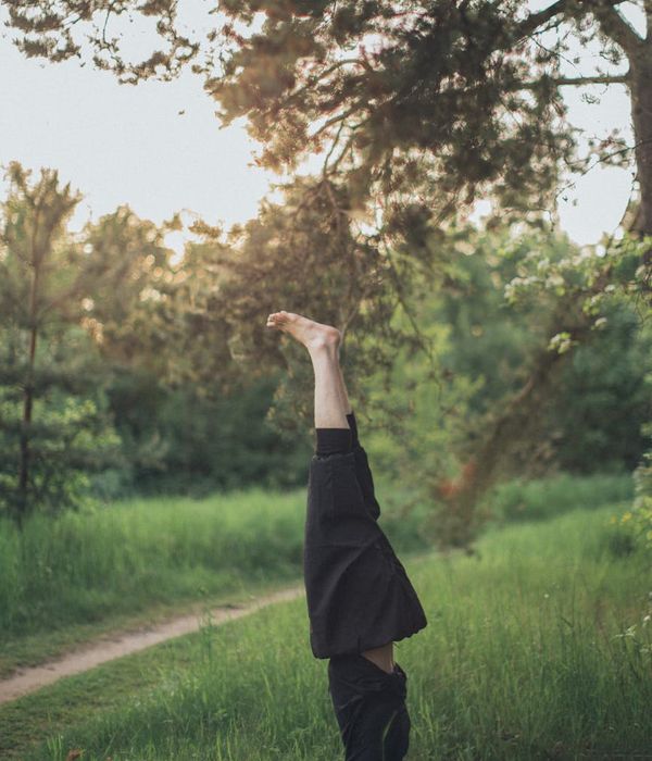 Person meditating peacefully in a natural green environment.